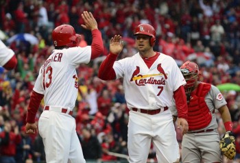 Apr 7, 2014; St. Louis, MO, USA; St. Louis Cardinals left fielder Matt Holliday (7) is congratulated by third baseman Matt Carpenter (13) after scoring on a three run double by catcher Yadier Molina (not pictured) during the first inning against the Cincinnati Reds at Busch Stadium. Mandatory Credit: Jeff Curry-USA TODAY Sports